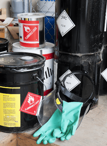 The image is of a group of barrels holding hazardous chemicals.